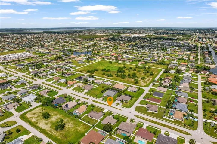 Aerial overview of property's location with nearby suburban area and a large body of water