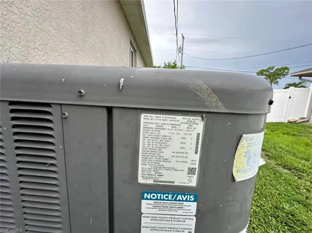 Exterior view of a central AC unit label says installed 08/2017