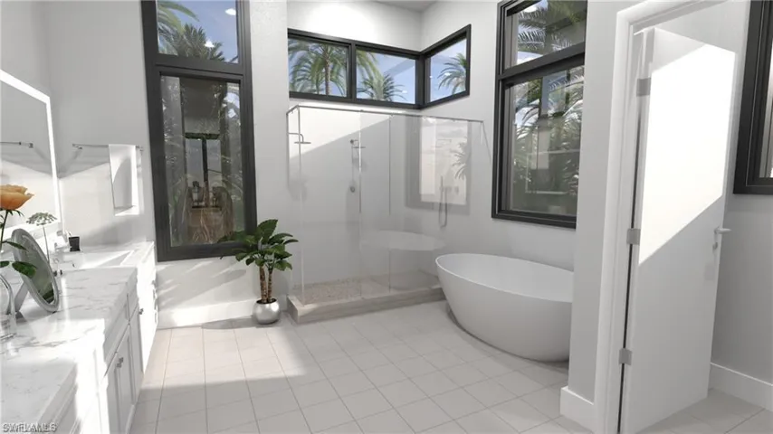 Bathroom with a freestanding bath, a shower stall, vanity, and light tile patterned floors