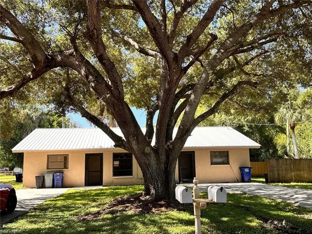 Single story home featuring a front lawn