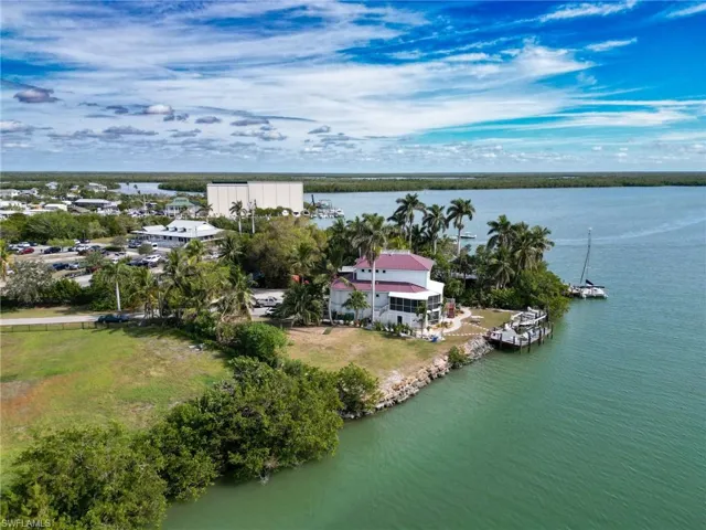 Birds eye view of property with a water view