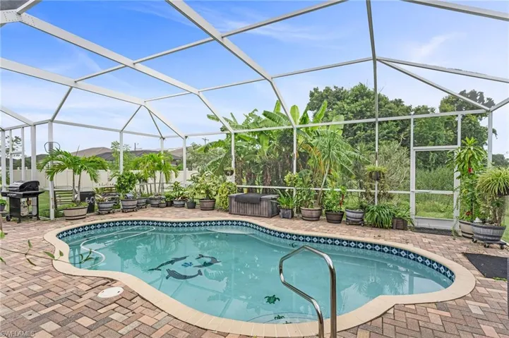 View of swimming pool with grilling area, a lanai, and a patio area
