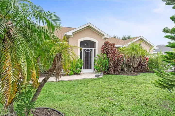 View of exterior entry with a lawn