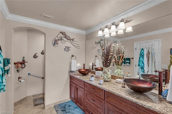 Bathroom featuring ornamental molding, vanity, and tile patterned floors