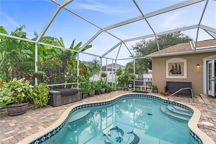 View of swimming pool featuring a lanai and a patio area