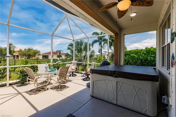 Unfurnished sunroom featuring ceiling fan