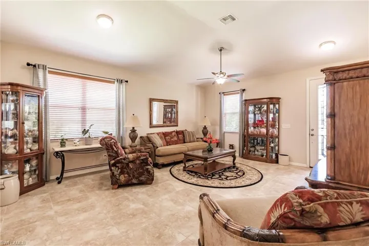 Living room featuring ceiling fan and light tile floors
