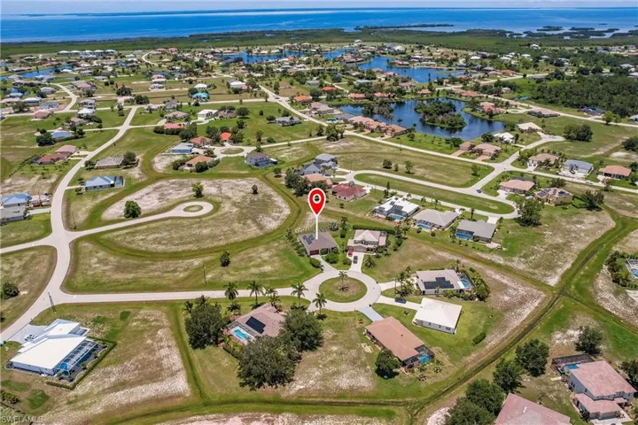 Birds eye view of property with a water view