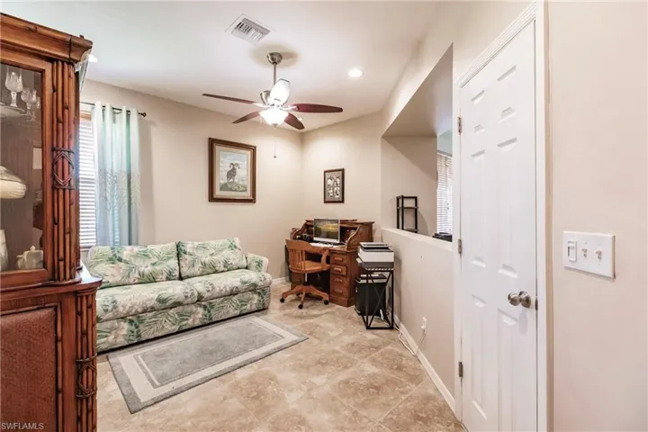 Office space with light tile flooring and ceiling fan