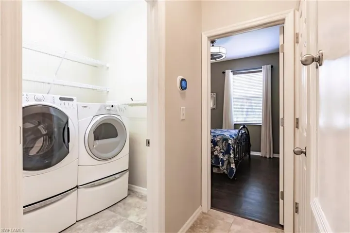 Washroom featuring washer and dryer and light wood-type flooring