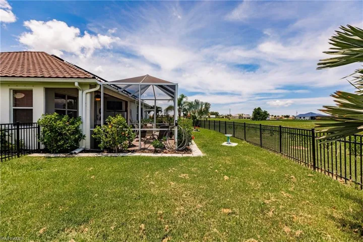 View of yard featuring glass enclosure