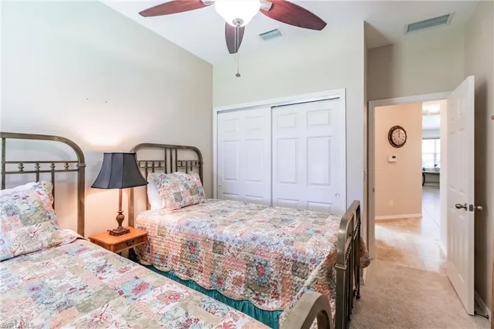 Bedroom featuring a closet, ceiling fan, and carpet floors