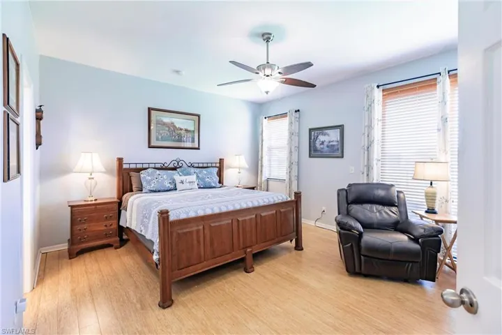 Bedroom with light hardwood / wood-style floors and ceiling fan