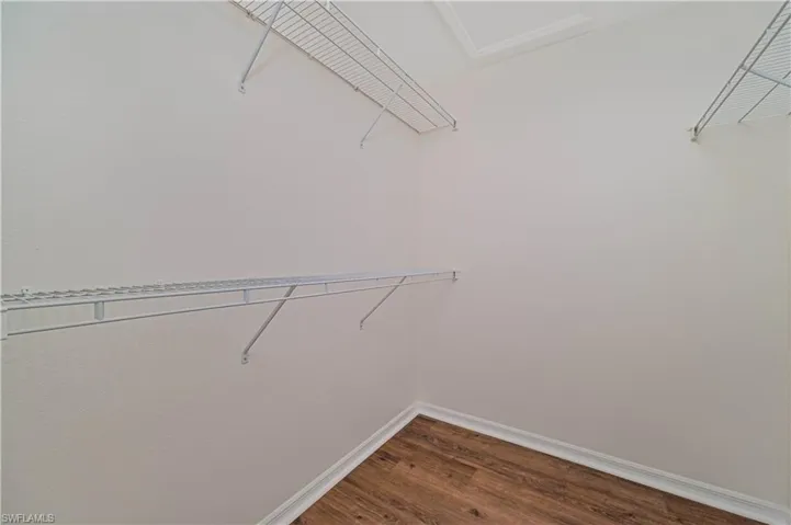 Walk in closet featuring hardwood / wood-style flooring