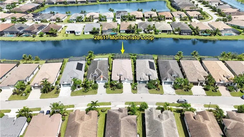Birds eye view of property with a water view