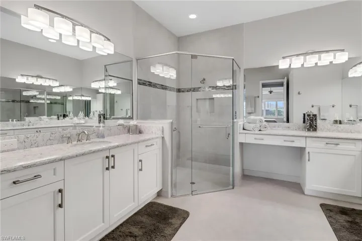 Bathroom featuring vanity, an enclosed shower, and ceiling fan