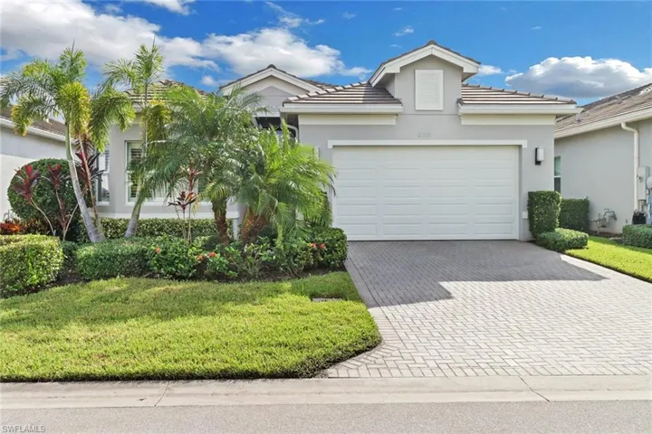 View of front of property with a garage and a front yard