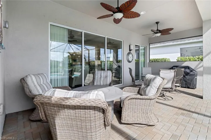 View of patio with grilling area and ceiling fan