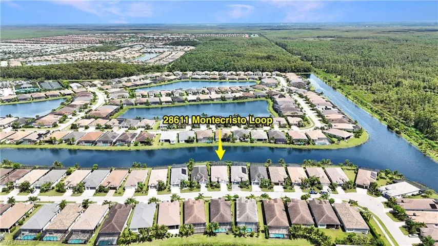Birds eye view of property with a water view