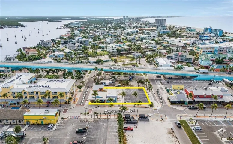 Aerial overview of property's location with a large body of water and property boundaries highlighted