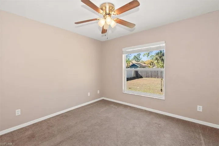 Unfurnished room with carpet flooring and a ceiling fan