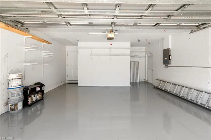 Garage with electric panel and a garage door opener