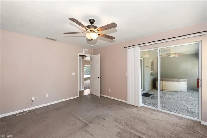 Unfurnished bedroom with carpet flooring and ceiling fan