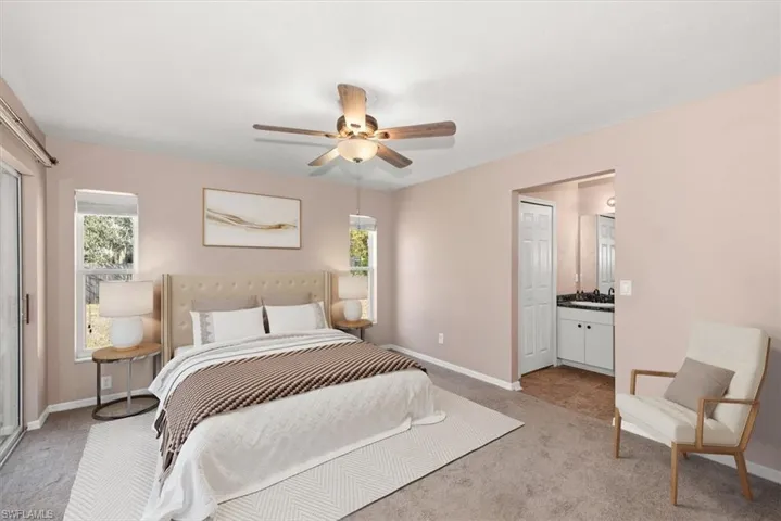 Carpeted bedroom featuring baseboards and a ceiling fan