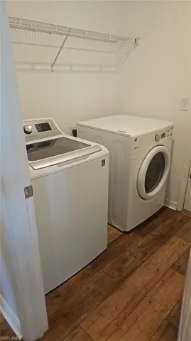 Dedicated utility space featuring durable wood-finish flooring and a convenient wire shelf