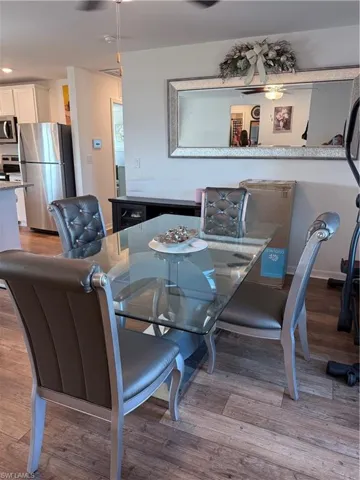 Dining room with light wood-type flooring and recessed lighting