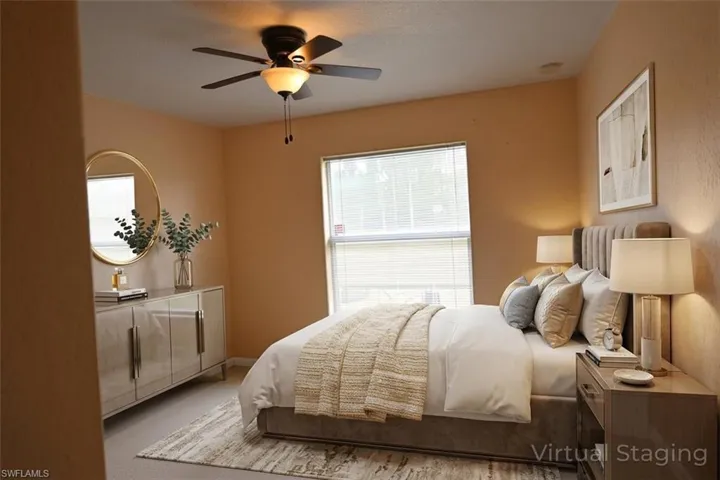 Carpeted bedroom featuring a ceiling fan and baseboards
