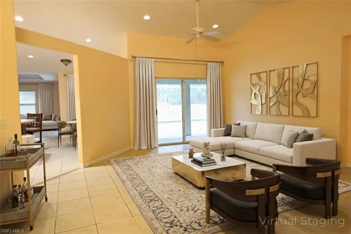 Living area featuring recessed lighting, light tile patterned floors, and a ceiling fan