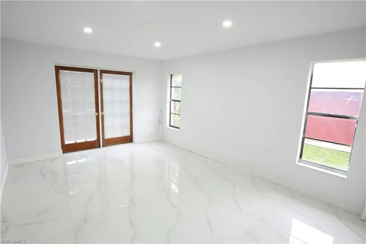 bedroom featuring light marble finish floors, recessed lighting, and a closet