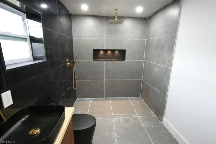Bedroom with a barn door leading to bathroom
