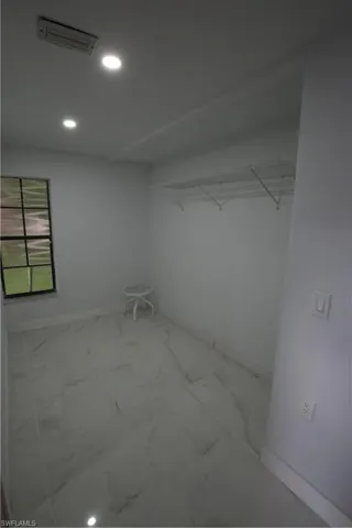 Full bathroom featuring vanity, walk in shower, and tile patterned flooring