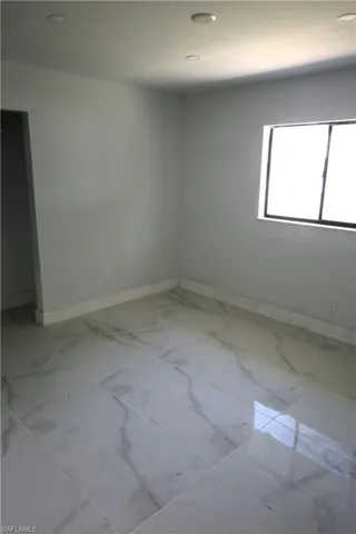Full bath with a freestanding tub, wood finish floors, vanity, and recessed lighting