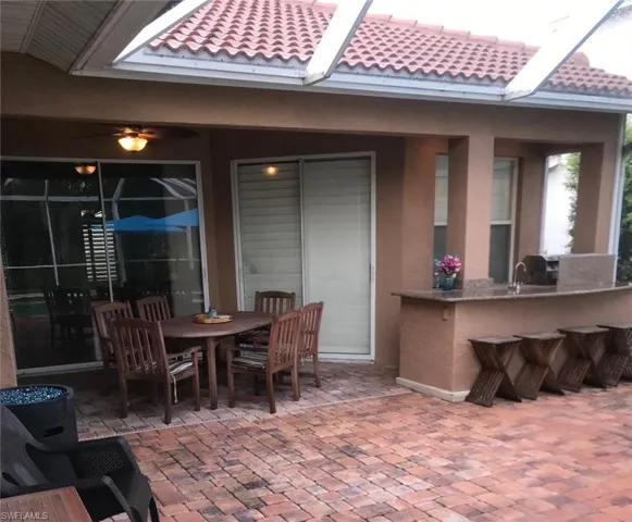 View of terrace featuring exterior bar