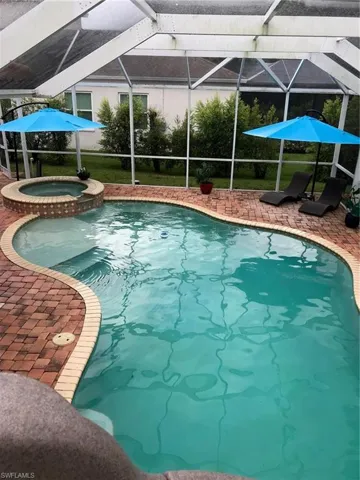 View of pool with a patio,  and an in ground hot tub