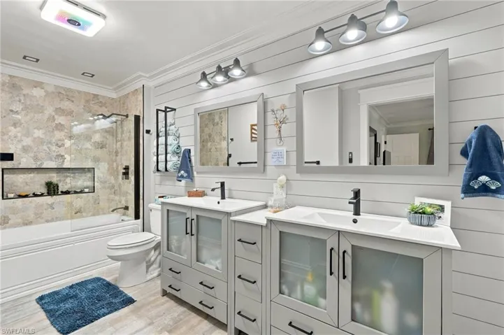 Dual vanity with light gray cabinetry and integrated sinks