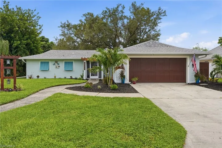 Concrete driveway leading to a two-car garage
