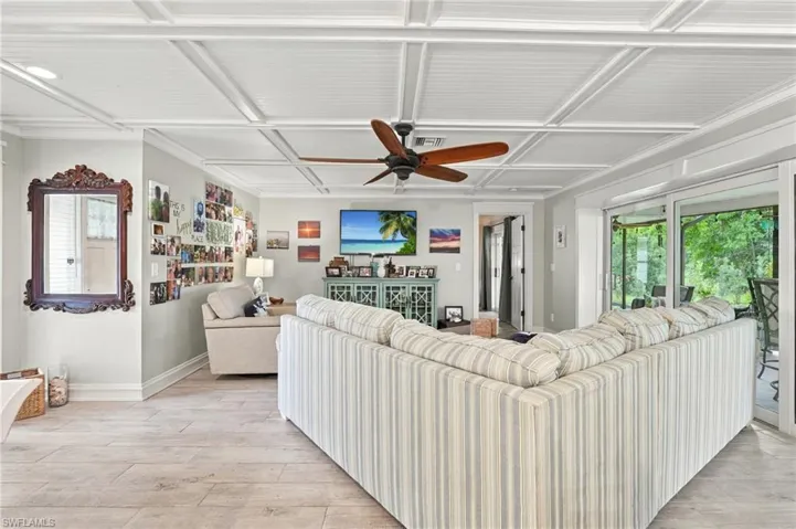 Wood-finish flooring with a white coffered ceiling