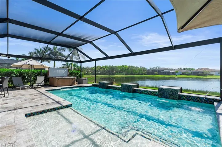 Custom pool with extended travertine lanai