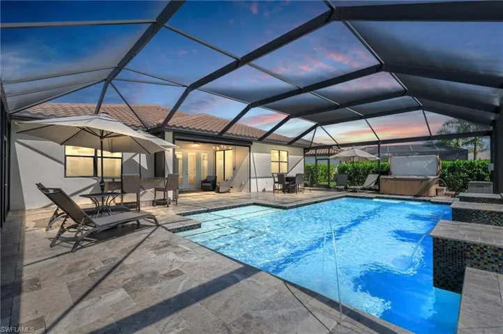 Custom pool with extended travertine lanai