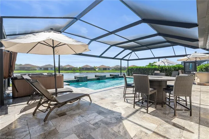 Custom pool with extended travertine lanai