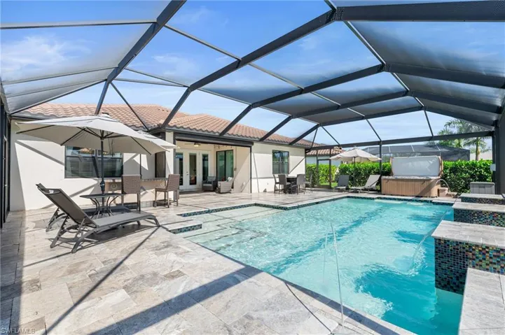 Custom pool with extended travertine lanai