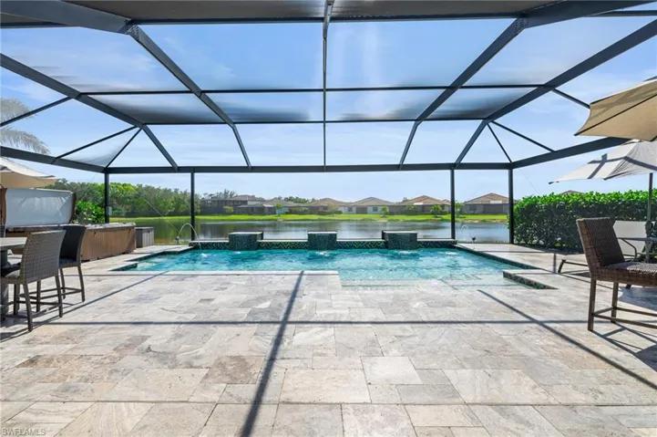 Custom pool with extended travertine lanai