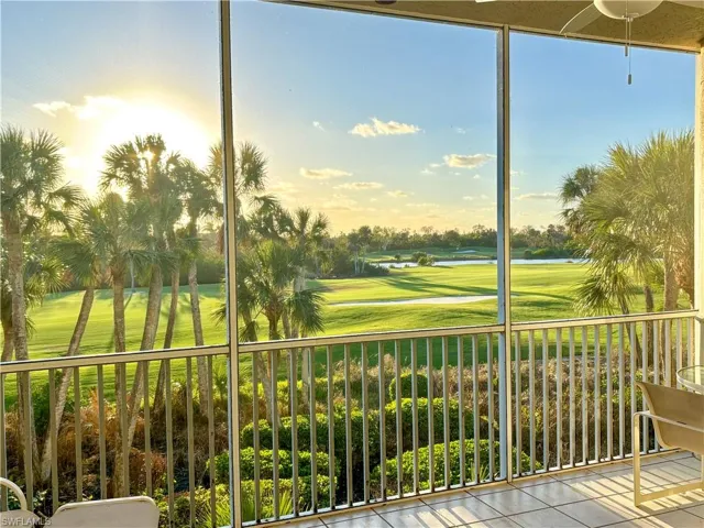 Sunroom / solarium featuring view of golf course