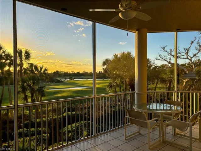 Sunroom featuring view of golf course