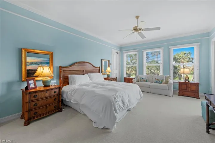 Bedroom with carpet, ornamental molding, baseboards, and ceiling fan