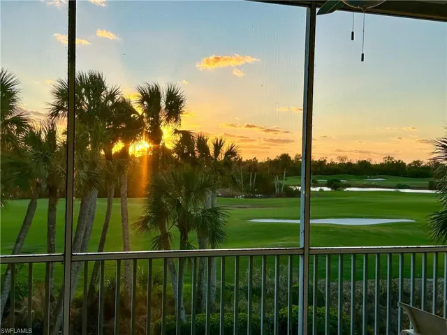 Surrounding community featuring view of golf course and a yard